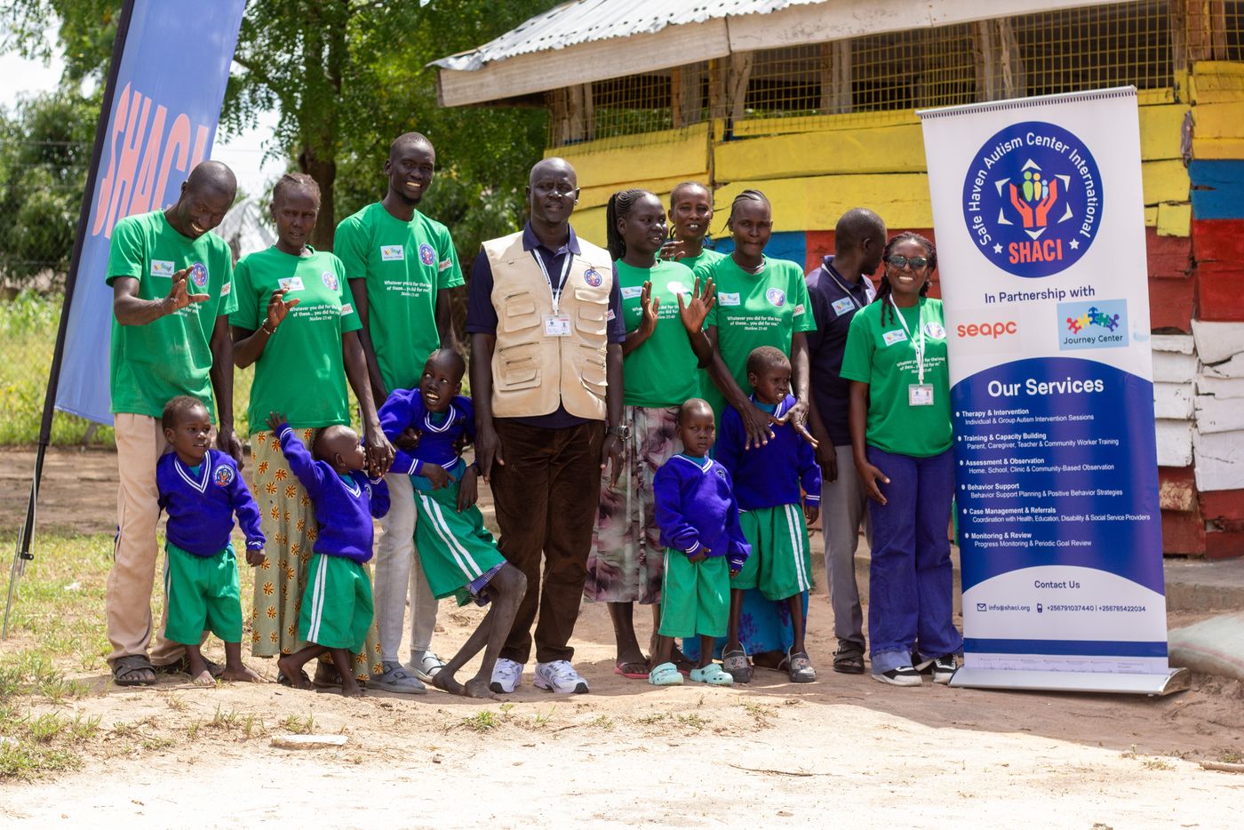 SHACI team, children, and families gathered together at a centre